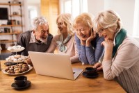 happy-senior-woman-her-friends-having-fun-while-surfing-internet-computer-home.jpg