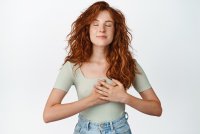 passionate-redhead-girl-holding-hands-heart-close-eyes-dreaming-thinking-something-heartwarming-dear-her-standing-white-backgrou.jpg